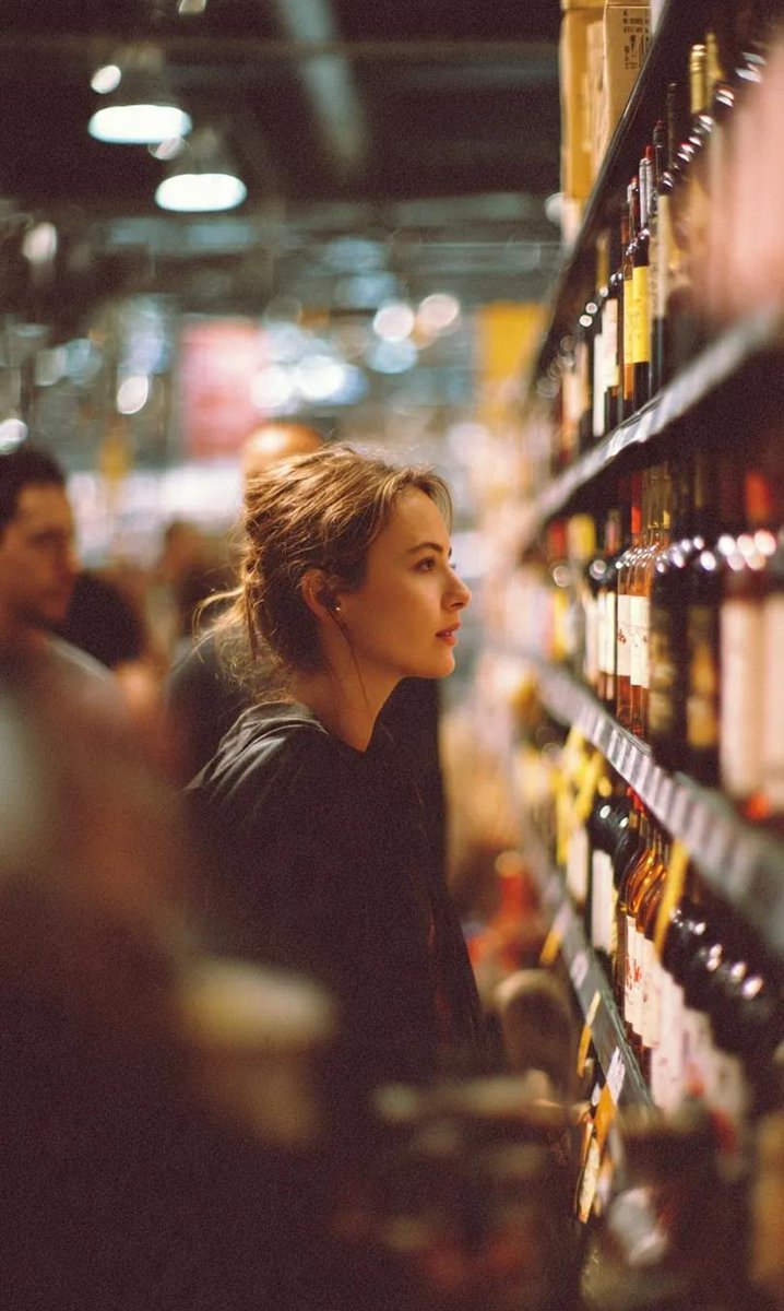 Woman Browsing Wine Selection